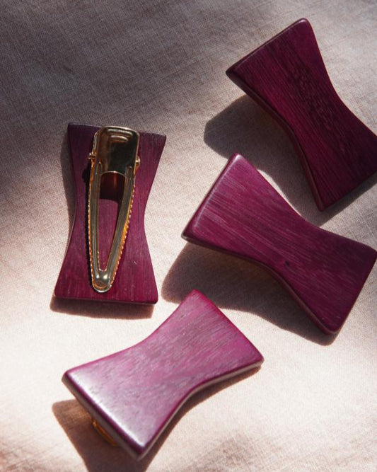 Purple wooden hair clips.