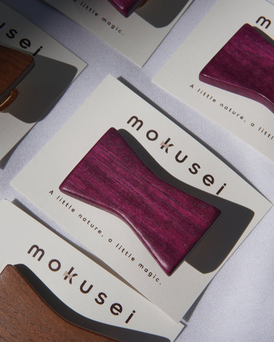 Mokusei product packaging with a purple hairclip on a light gray background